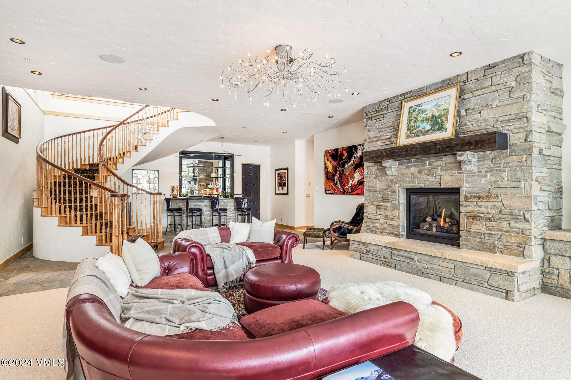 319 Granada Glen Road Edwards, CO 81632 - Photo 27 of 43 a living room with furniture a fireplace and a chandelier