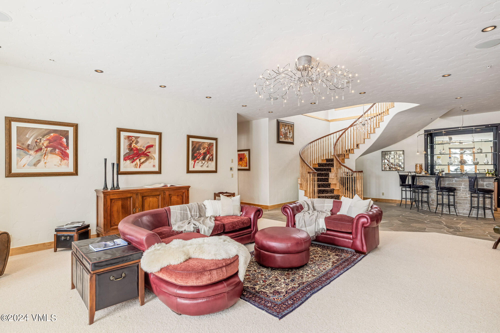 319 Granada Glen Road Edwards, CO 81632 - Photo 28 of 43 a living room with furniture a rug and a chandelier