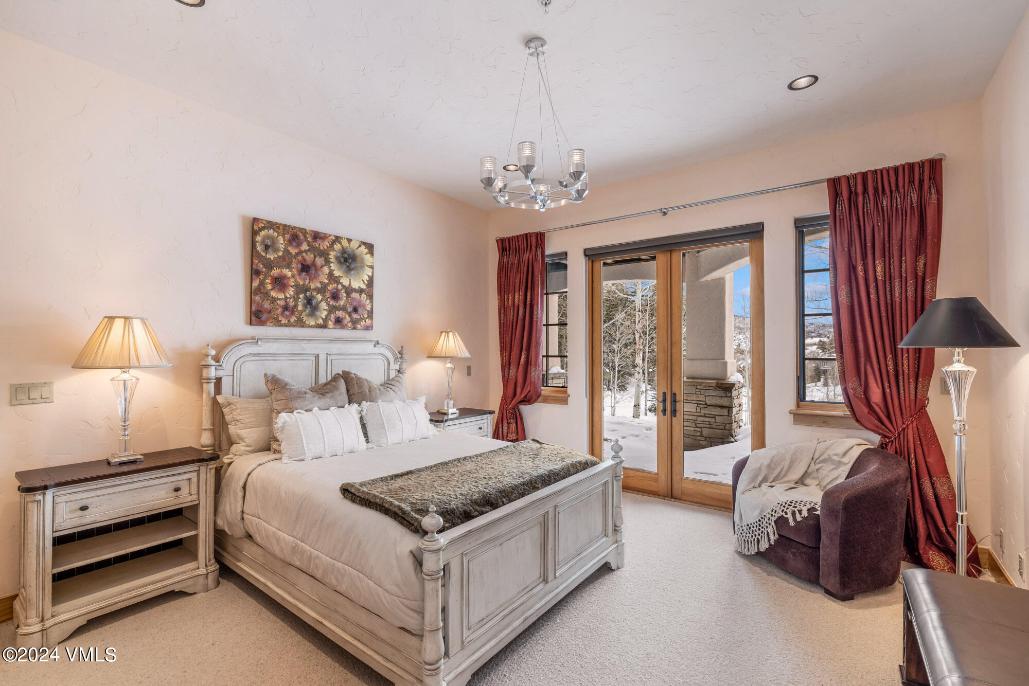 319 Granada Glen Road Edwards, CO 81632 - Photo 35 of 43 a bed room with a bed and a chandelier