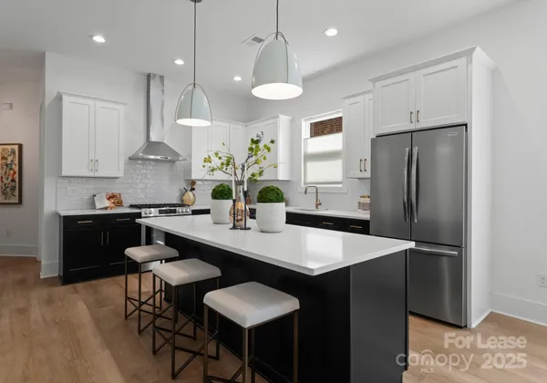 a kitchen with granite countertop a sink a center island and stainless steel appliances