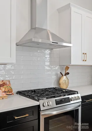a stove top oven sitting inside of a kitchen