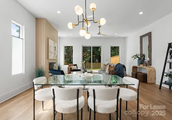 a view of a dining room with furniture wooden floor and chandelier