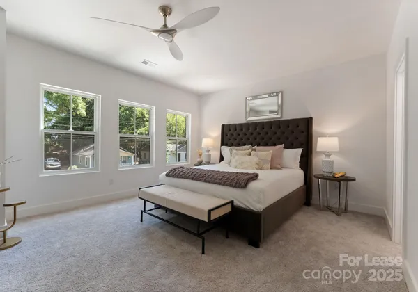 a bed sitting in a bedroom next to a window