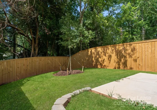 a view of garden with deck in the back
