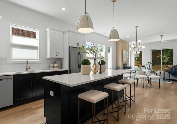 a large kitchen with a table and chairs