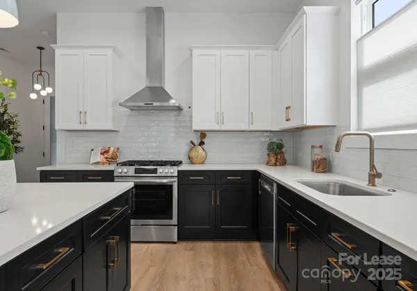 a kitchen with a sink stove and cabinets