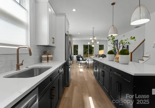 a kitchen with counter top space sink and center island