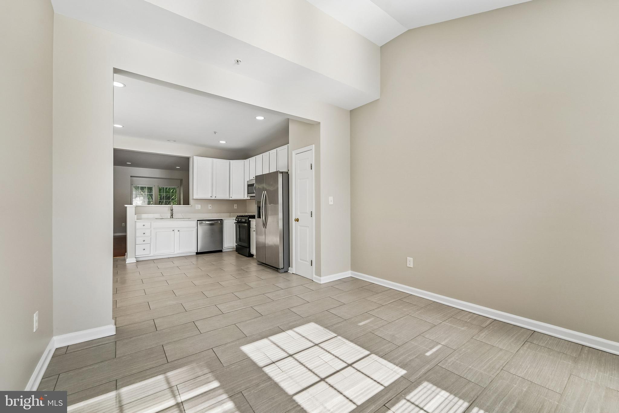 1461 Pangbourne Way Hanover, MD 21076 - Photo 19 of 51 a view of a kitchen with white cabinets and refrigerator