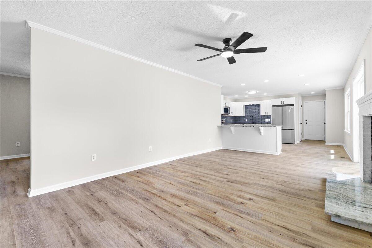 133 Starling Lane Callaway, VA 24067 - Photo 14 of 56 a view of a kitchen with wooden floor and a ceiling fan