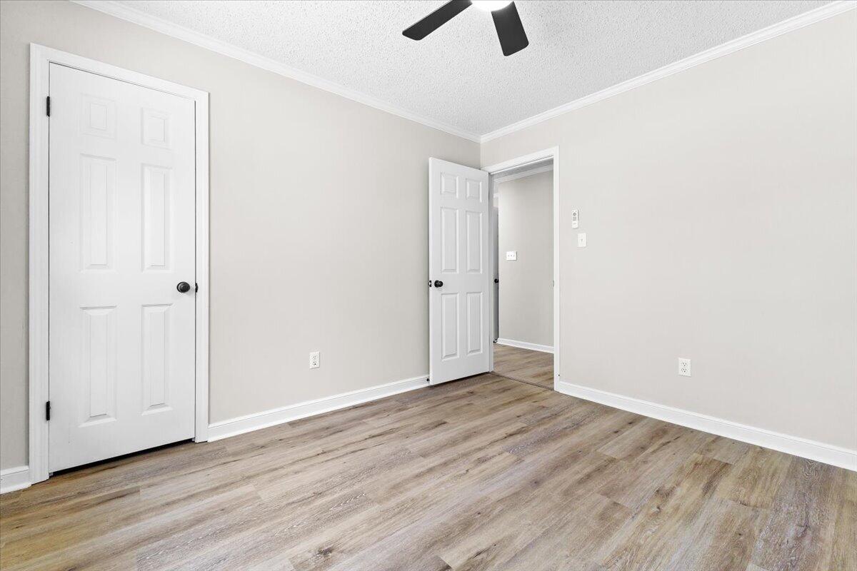 133 Starling Lane Callaway, VA 24067 - Photo 26 of 56 an empty room with ceiling fan wooden floor and windows