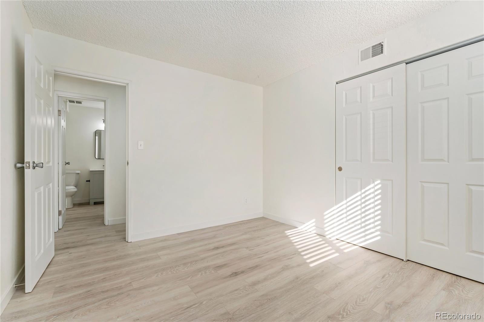 209 East Highline Circle, Unit 108 Centennial, CO 80122 - Photo 14 of 22 a view of a bathroom with wooden floor and a bathroom