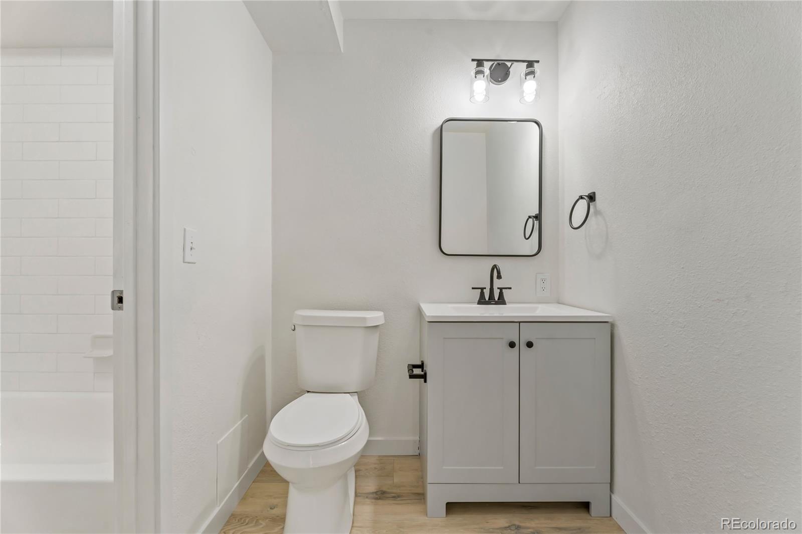 209 East Highline Circle, Unit 108 Centennial, CO 80122 - Photo 15 of 22 a bathroom with a toilet sink and mirror