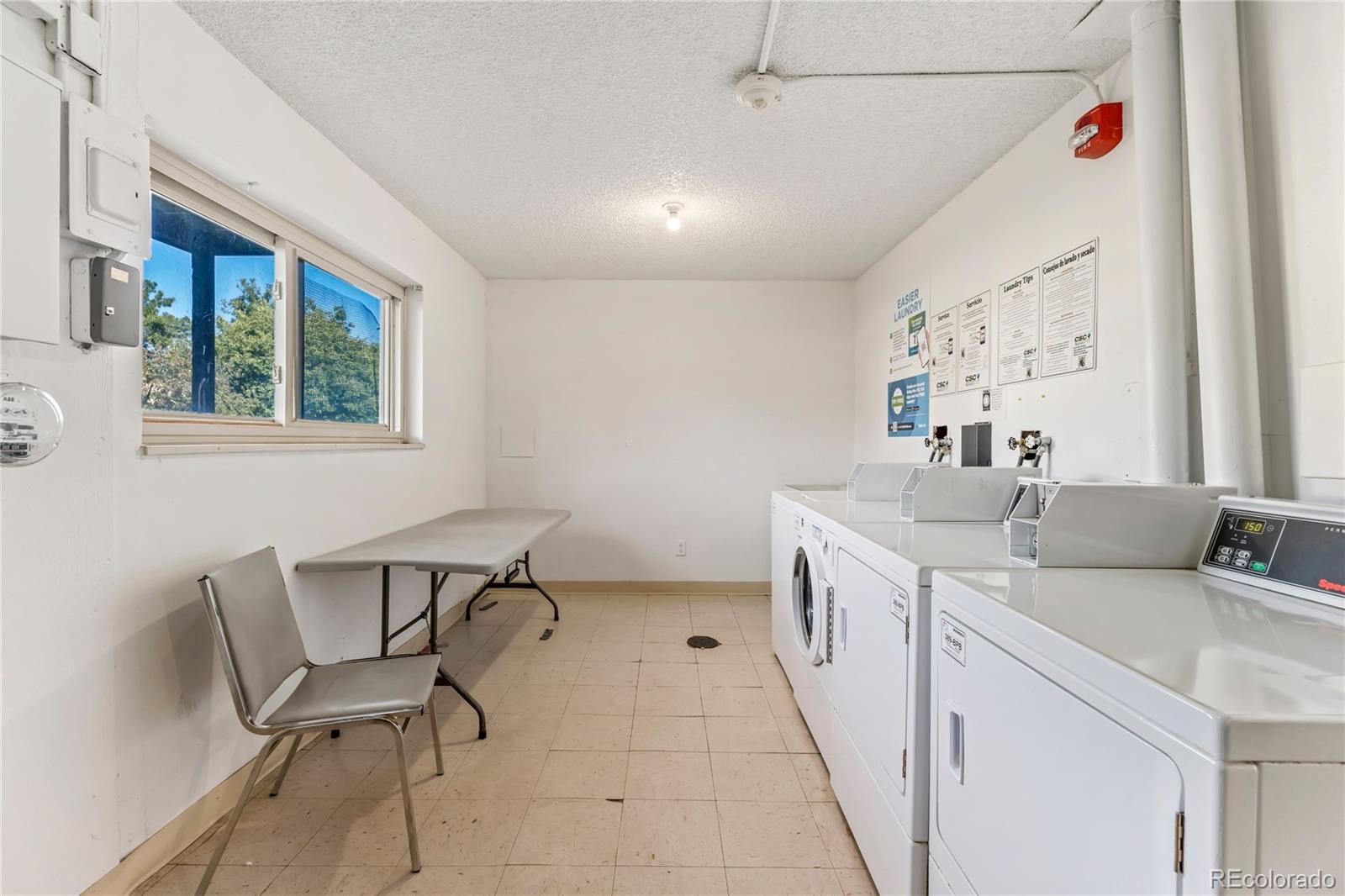 209 East Highline Circle, Unit 108 Centennial, CO 80122 - Photo 16 of 22 a kitchen with a sink and chairs
