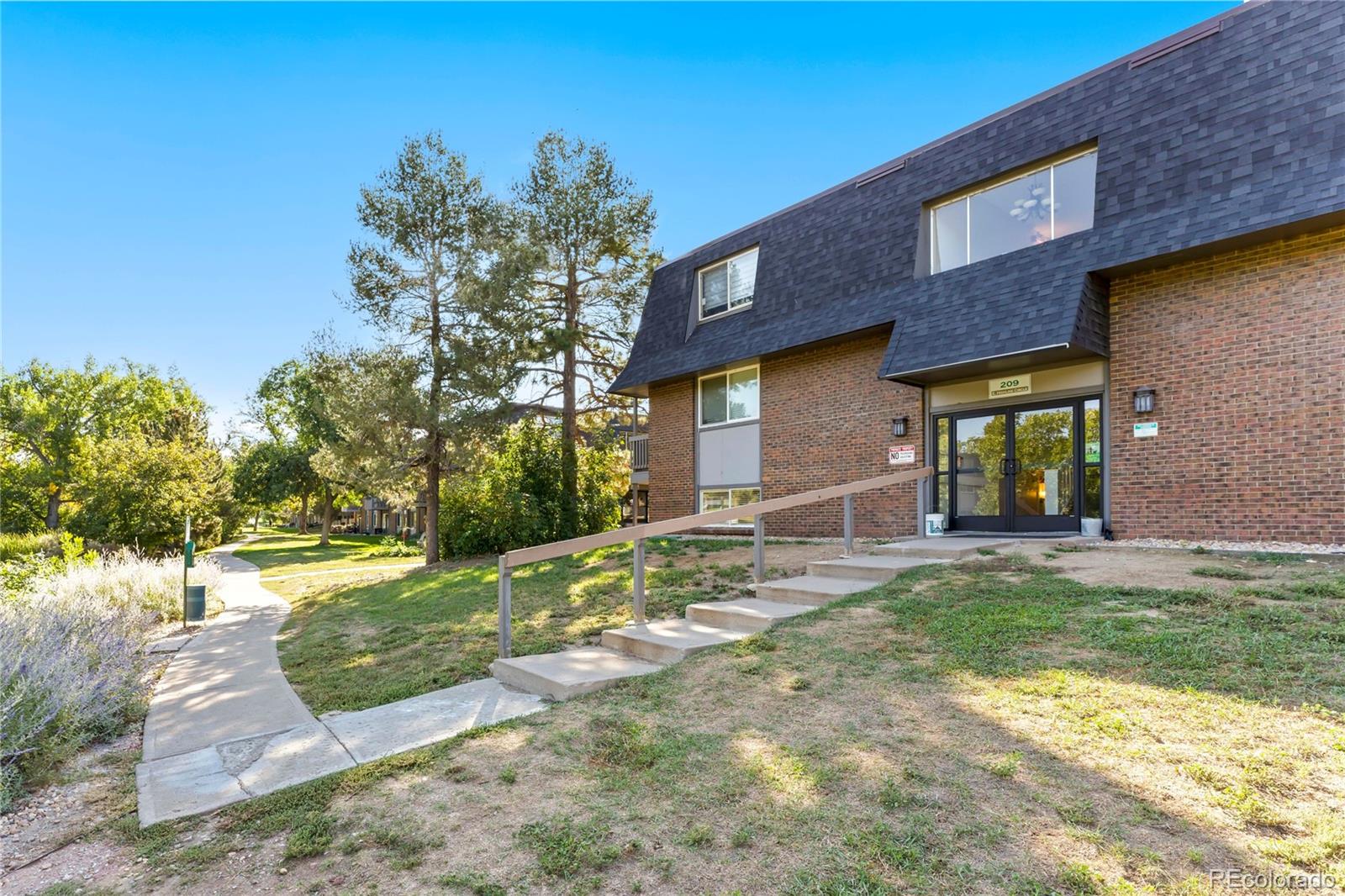 209 East Highline Circle, Unit 108 Centennial, CO 80122 - Photo 17 of 22 a view of a house with a yard and plants
