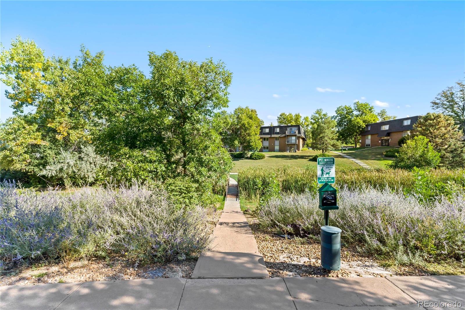 209 East Highline Circle, Unit 108 Centennial, CO 80122 - Photo 18 of 22 a view of a lake with a house in the background