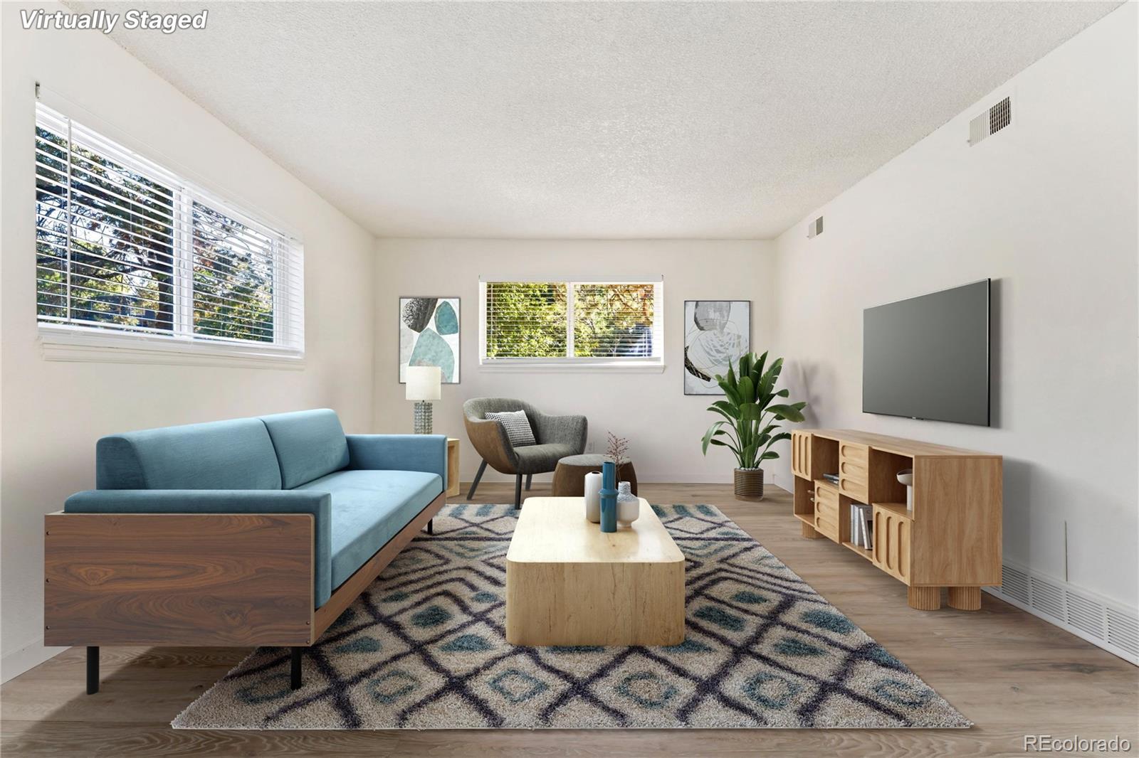 209 East Highline Circle, Unit 108 Centennial, CO 80122 - Photo 2 of 22 a living room with furniture and a flat screen tv