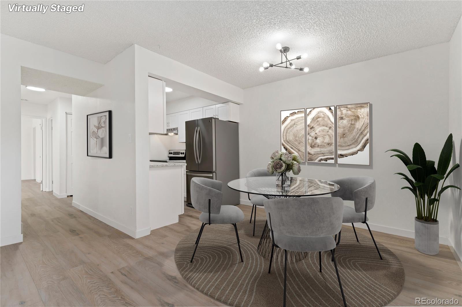 209 East Highline Circle, Unit 108 Centennial, CO 80122 - Photo 3 of 22 a view of a dining room with furniture and chandelier