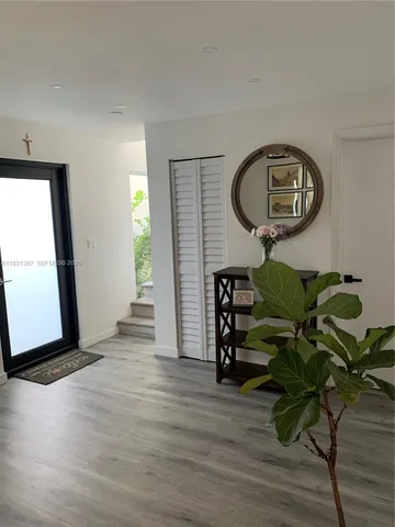 a view of a livingroom with furniture and hardwood floor