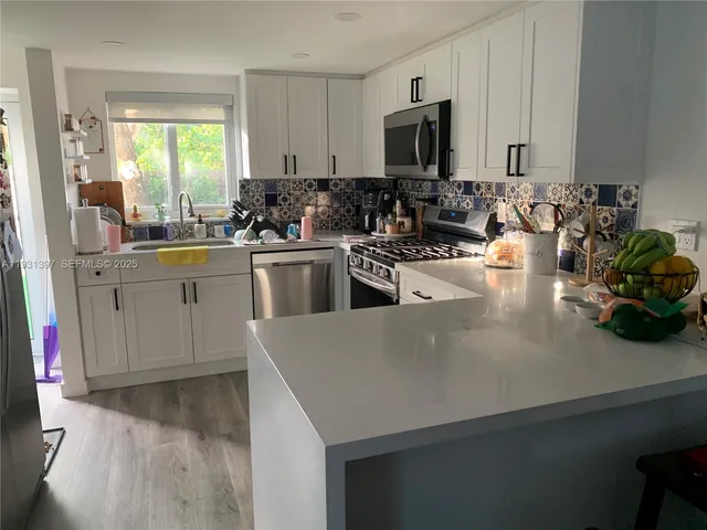 a kitchen with a sink cabinets and window