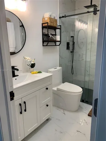a bathroom with a sink a toilet and a mirror