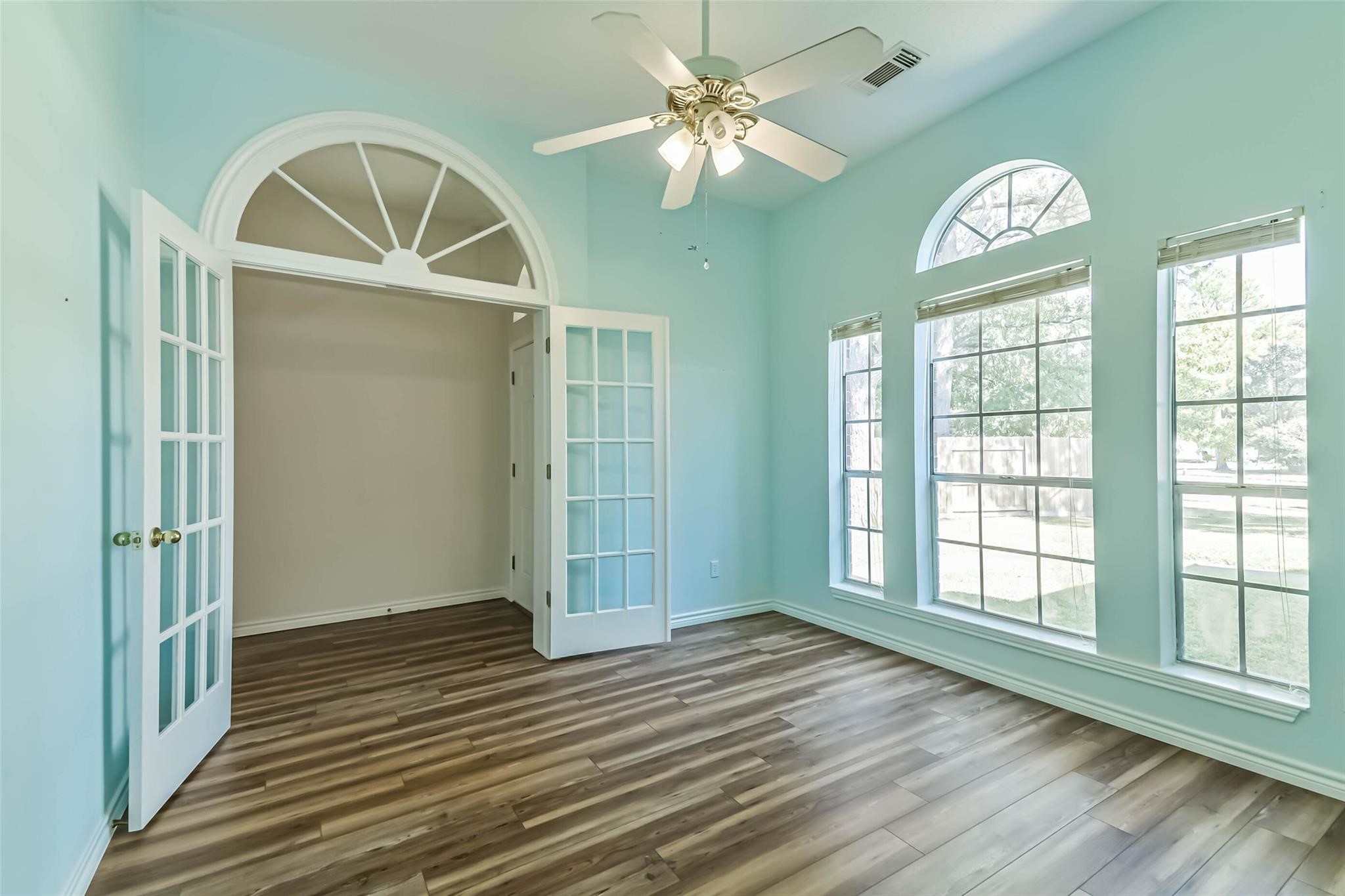 15027 Winding Black Cherry Lane Cypress, TX 77433 - Photo 12 of 37 wooden floor in an empty room with a window