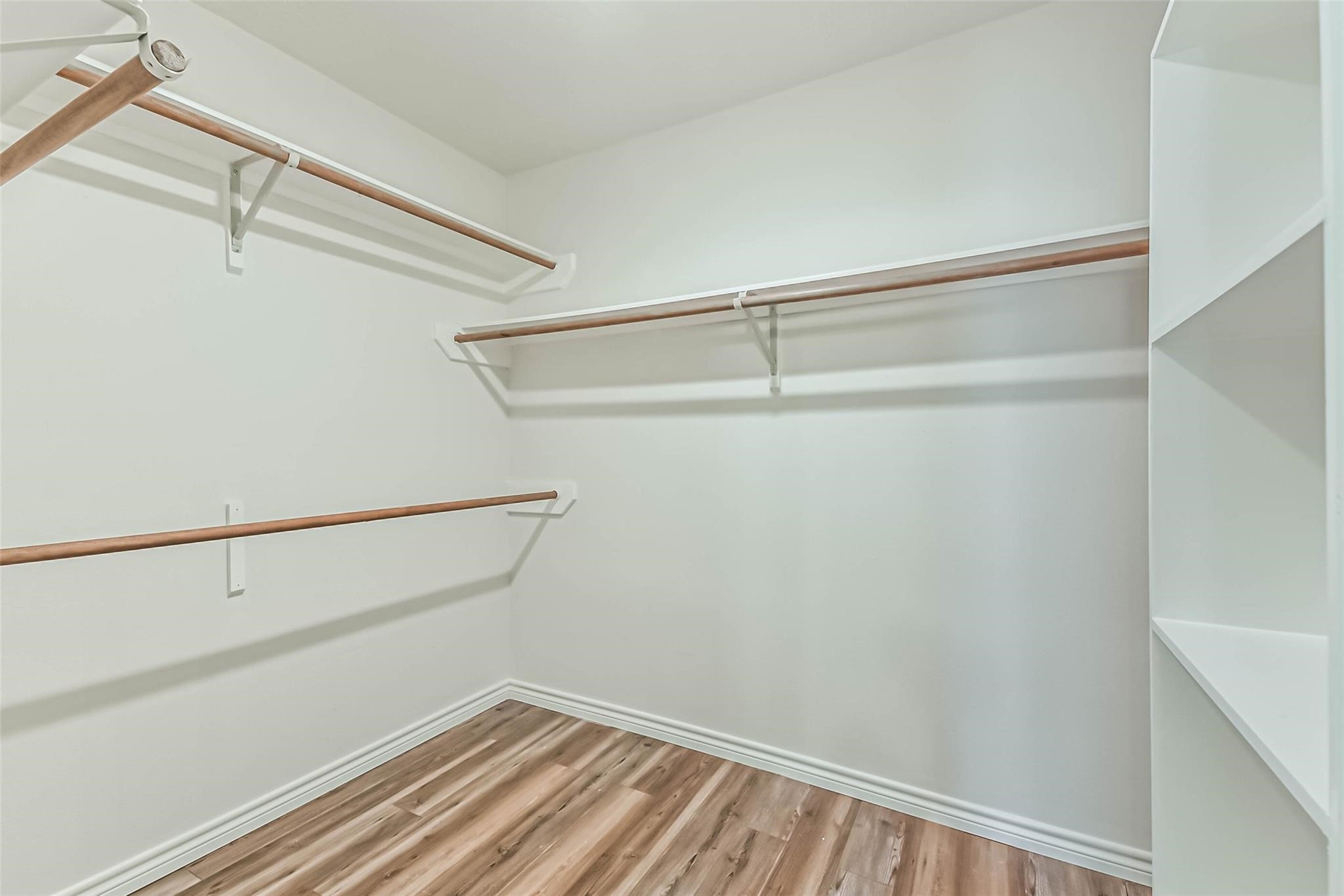 15027 Winding Black Cherry Lane Cypress, TX 77433 - Photo 17 of 37 a view of small space with racks on the wall