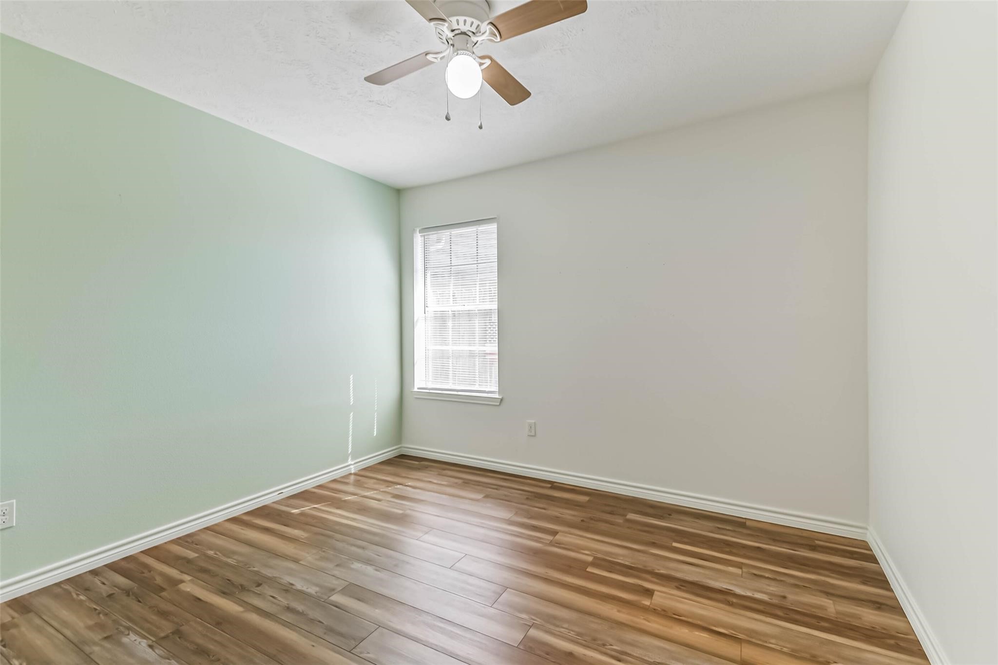 15027 Winding Black Cherry Lane Cypress, TX 77433 - Photo 18 of 37 wooden floor in an empty room with a window