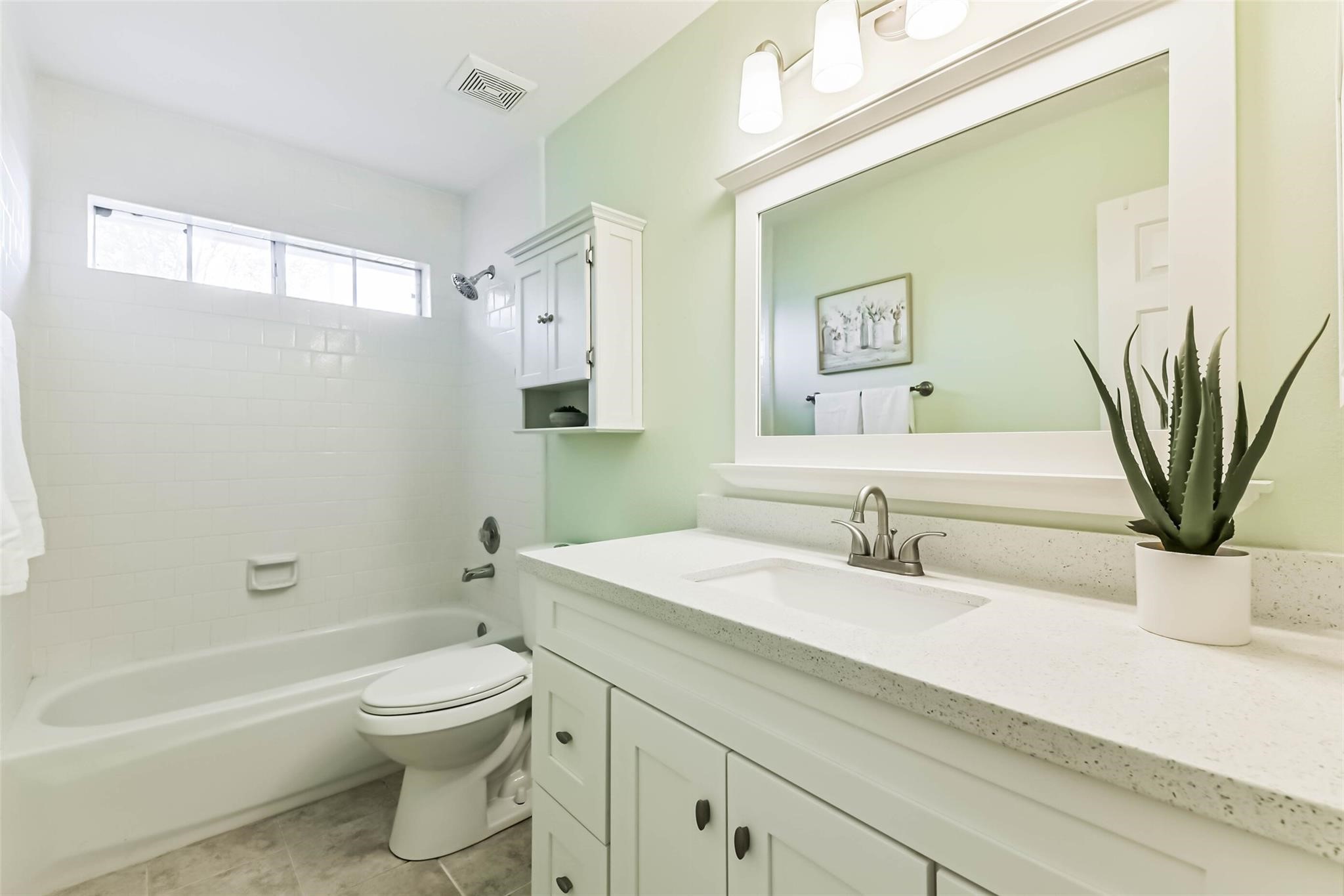 15027 Winding Black Cherry Lane Cypress, TX 77433 - Photo 20 of 37 a bathroom with a sink a toilet and a bathtub