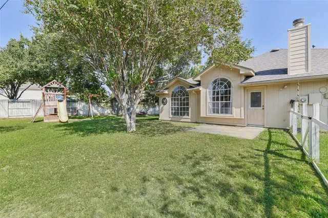a view of a backyard with a small cabin