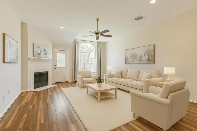 a living room with furniture a fireplace and a chandelier