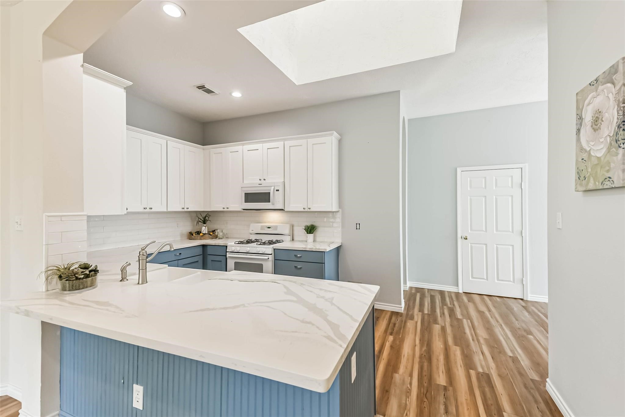 15027 Winding Black Cherry Lane Cypress, TX 77433 - Photo 5 of 37 a kitchen with a stove a sink a refrigerator and cabinets