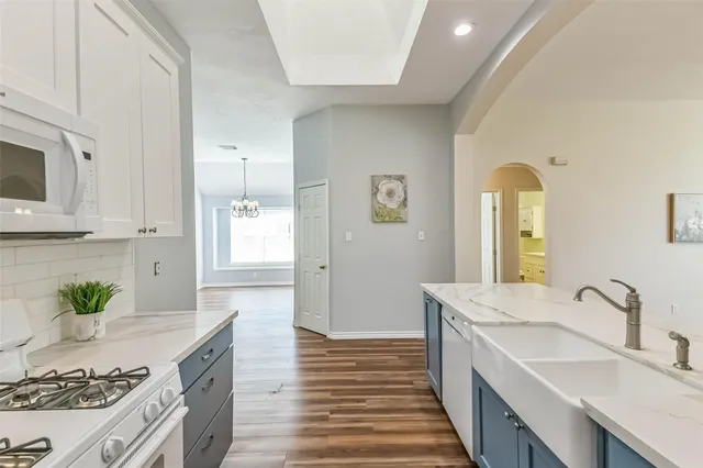 a spacious bathroom with a granite countertop sink and a mirror
