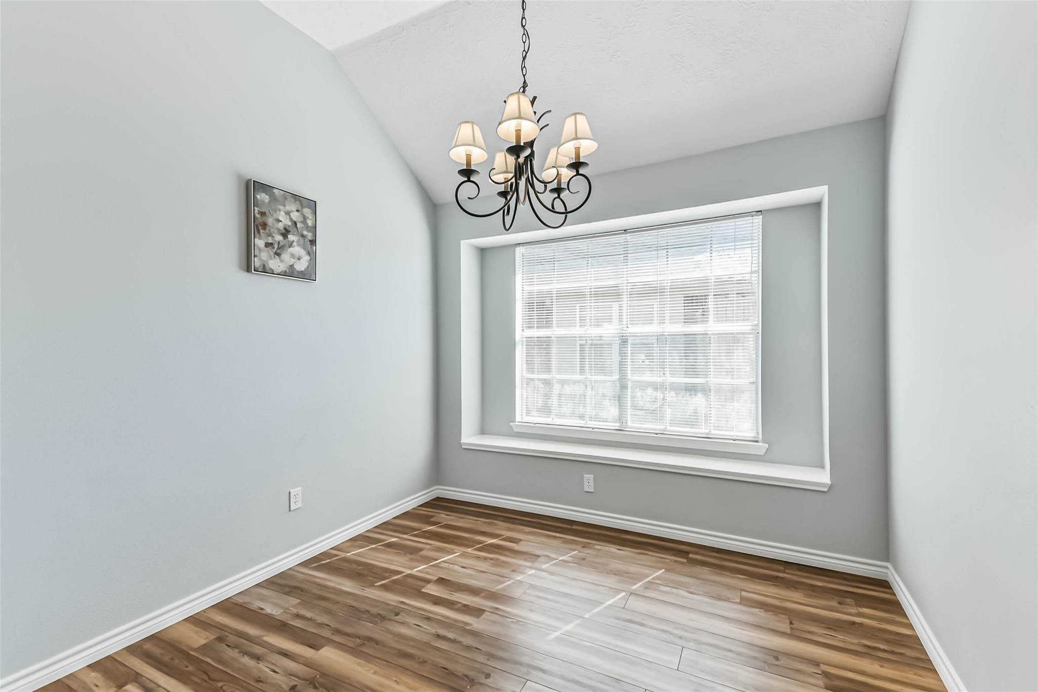 15027 Winding Black Cherry Lane Cypress, TX 77433 - Photo 9 of 37 a view of an empty room with window and wooden floor