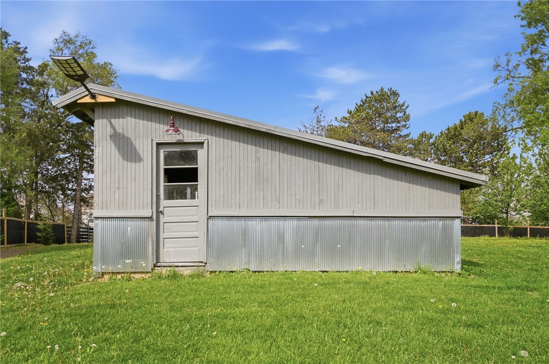 6155 North Union Road Clayton, OH 45315 - Photo 56 of 59 This charming shed offers practical outdoor storage and rustic appeal amidst a lush green lawn.