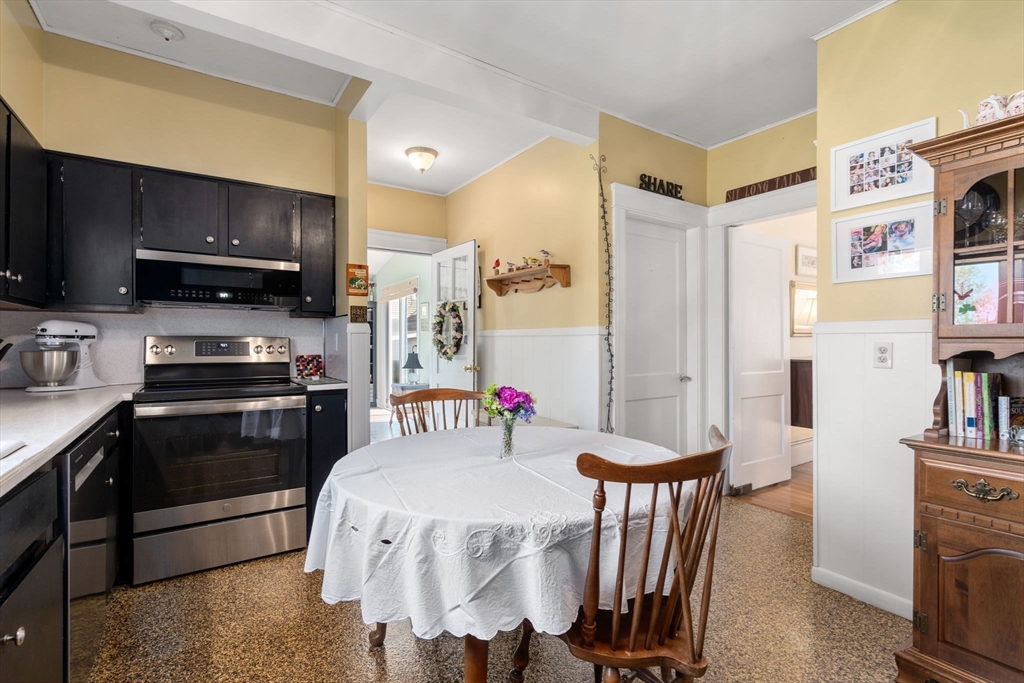 1 Brighton Road Worcester, MA 01606 - Photo 15 of 30 a kitchen with stainless steel appliances kitchen island granite countertop a refrigerator a stove a microwave a sink and dishwasher