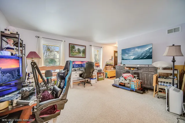 a living room with lots of furniture and a flat screen tv