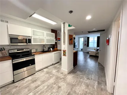 a view of a kitchen with a sink and cabinets