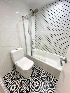 a bathroom with a bathtub and shower