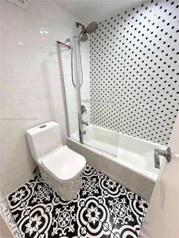 a bathroom with a bathtub and shower