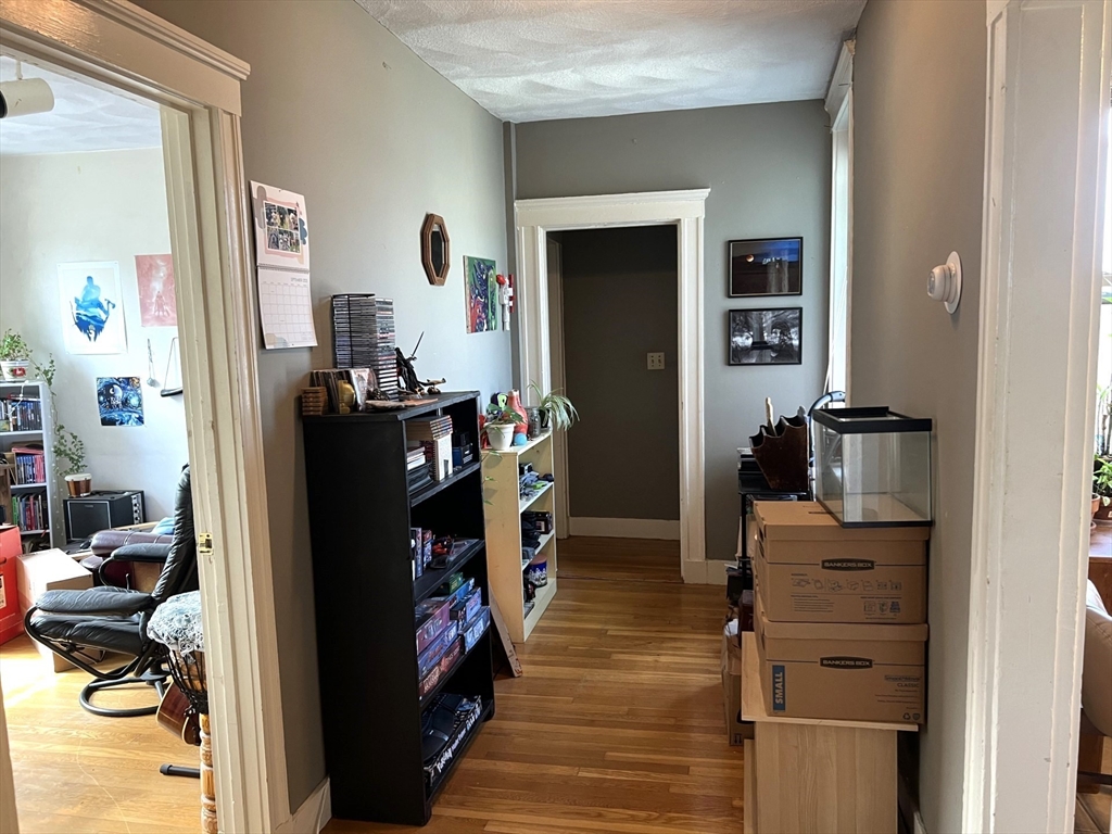 28 Ransom Road, Unit 11 Boston, MA 02135 - Photo 13 of 16 a view of a bedroom with workspace and living room