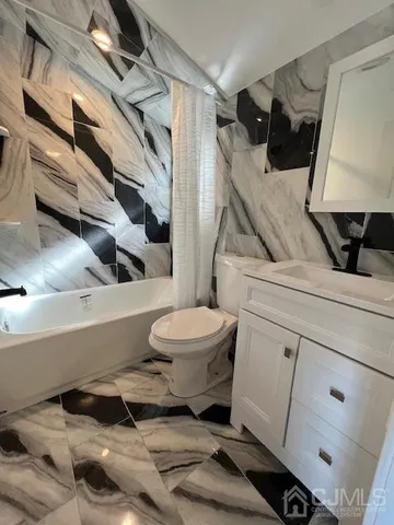a bathroom with a toilet a sink and bathtub