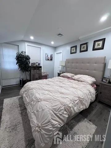 a large bed sitting in a bedroom and chandelier