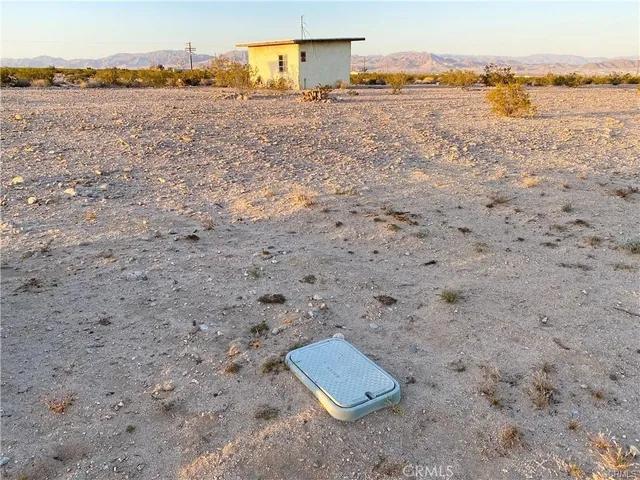a view of a lake with beach and mountain view