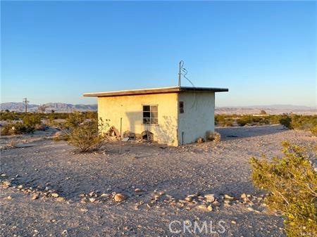 0 Pole Line Road Twentynine Palms, CA 92277 - Photo 4 of 12 a view of a dry yard with wooden fence