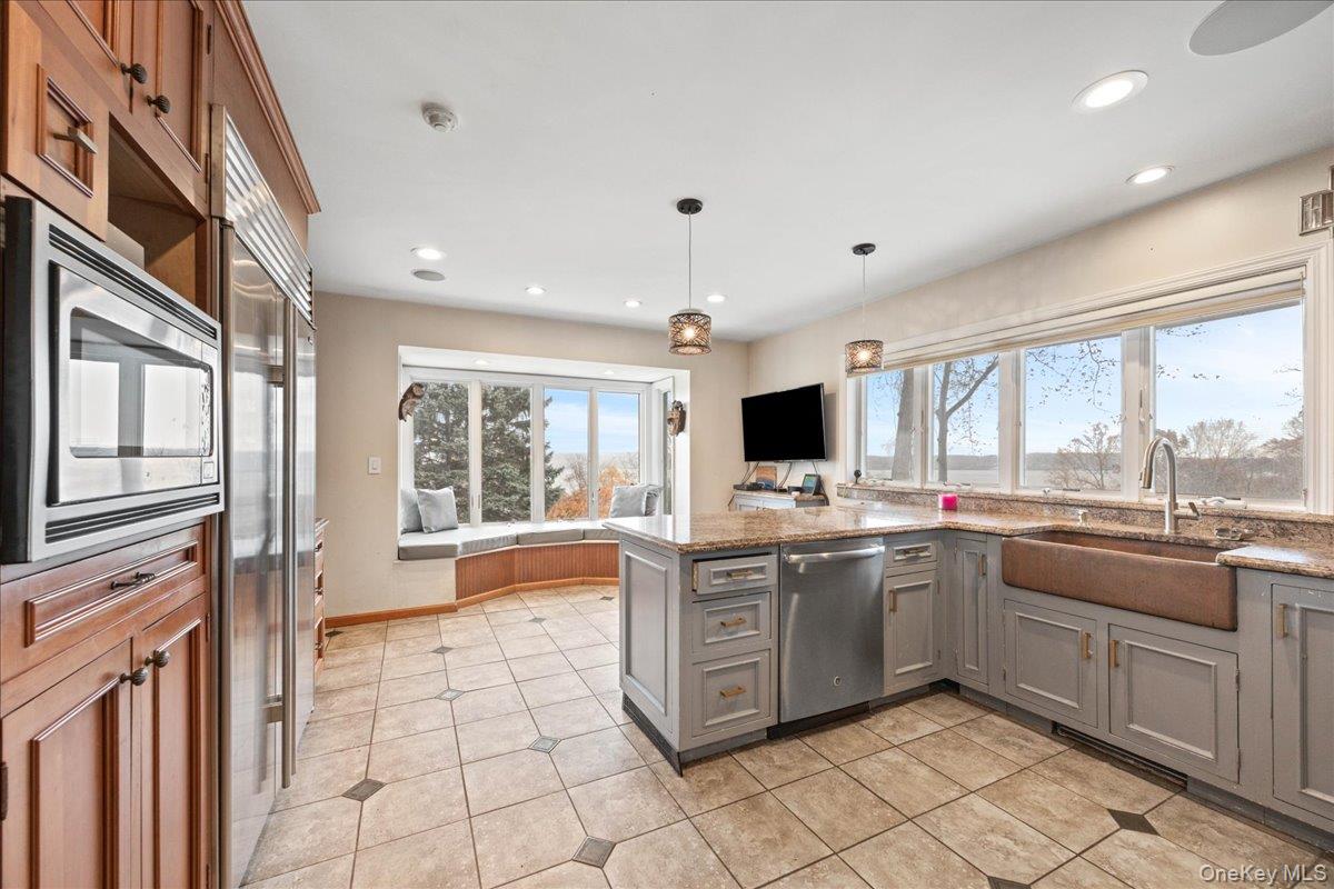 772 Rte 9W Nyack, NY 10960 - Photo 5 of 18 Kitchen featuring a peninsula, gray cabinetry, light stone countertops, built in appliances, and hanging light fixtures
