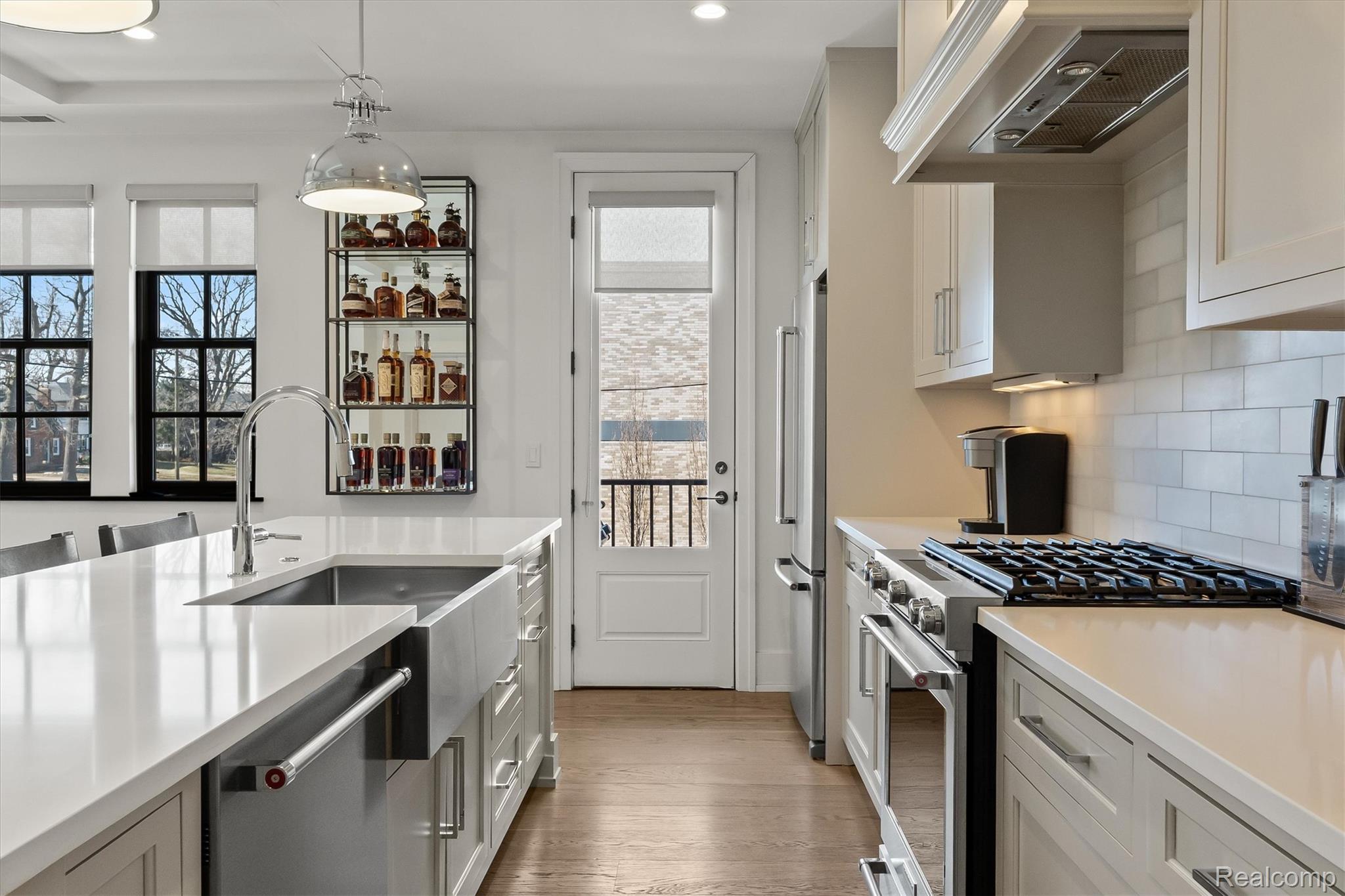 936 West Eleven Mile Road Royal Oak, MI 48067 - Photo 6 of 19 Kitchen with stainless steel appliances, pendant lighting, light wood-style floors, and healthy amount of natural light