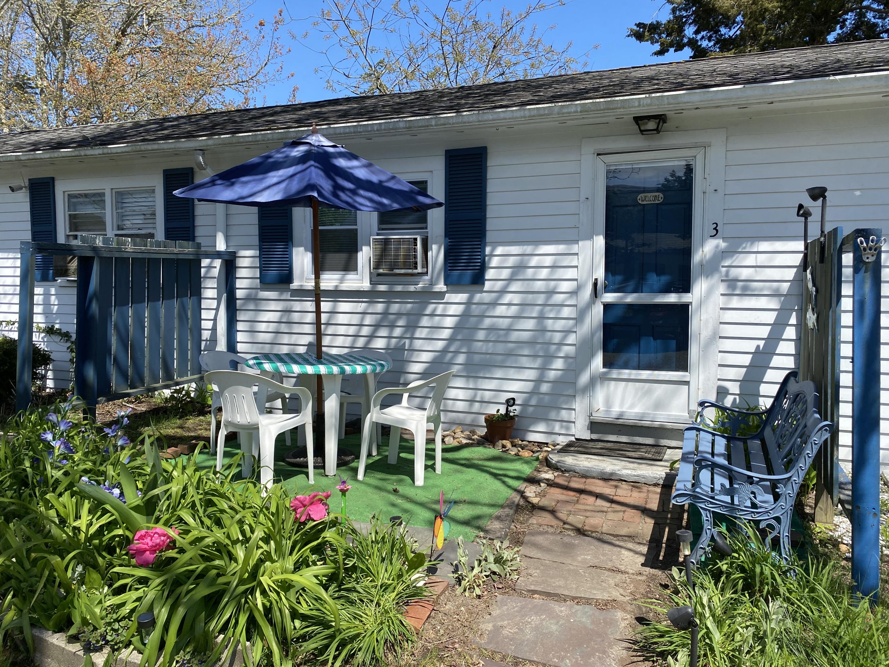 465 Lower County Road, Unit 3A Dennis Port, MA 02639 - Photo 1 of 33 a front view of a house with patio