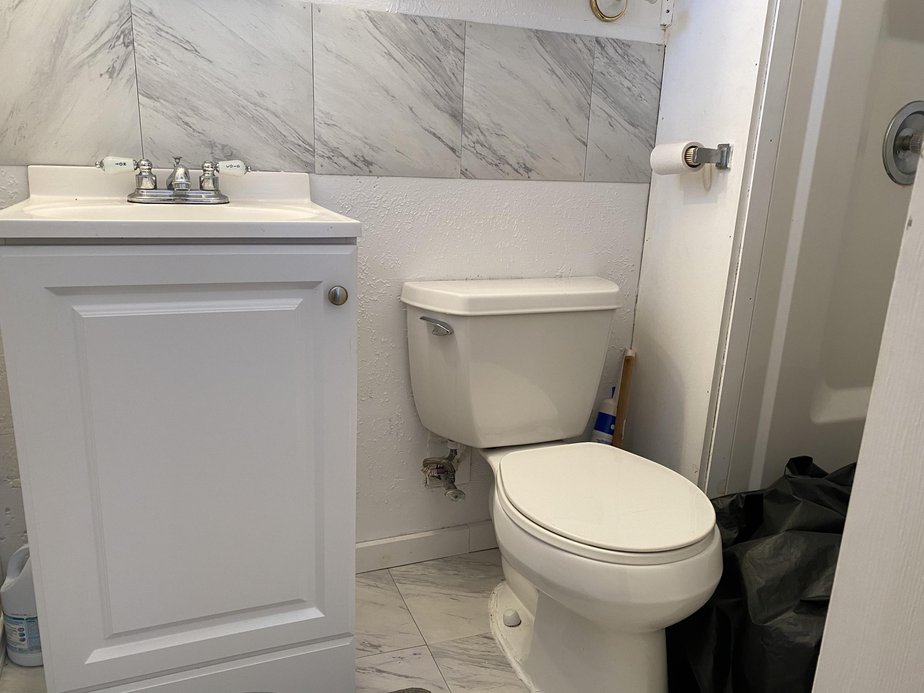 465 Lower County Road, Unit 3A Dennis Port, MA 02639 - Photo 21 of 33 a white toilet sitting next to a bathroom sink