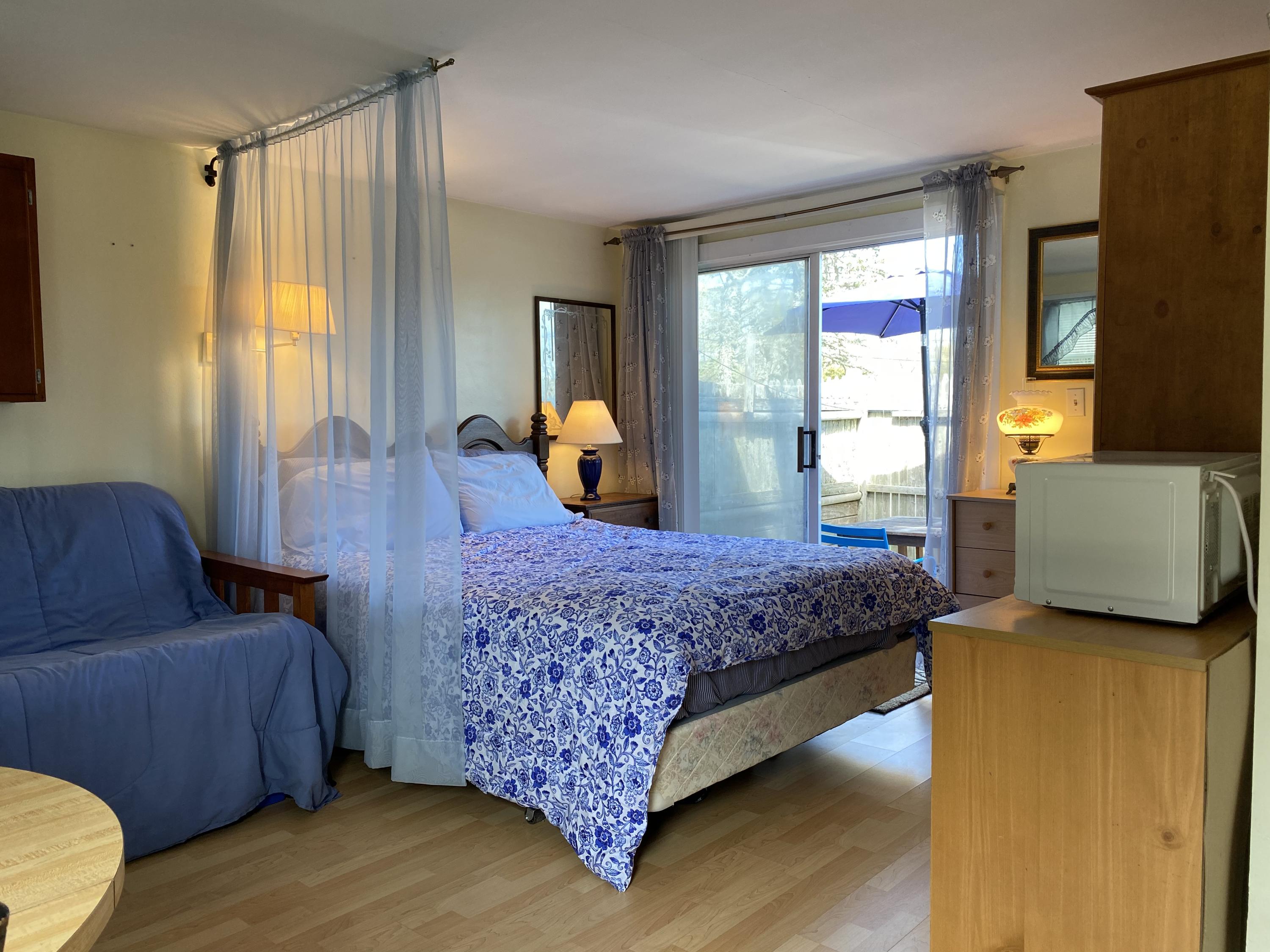 465 Lower County Road, Unit 3A Dennis Port, MA 02639 - Photo 3 of 33 a bedroom with a bed and wooden floor