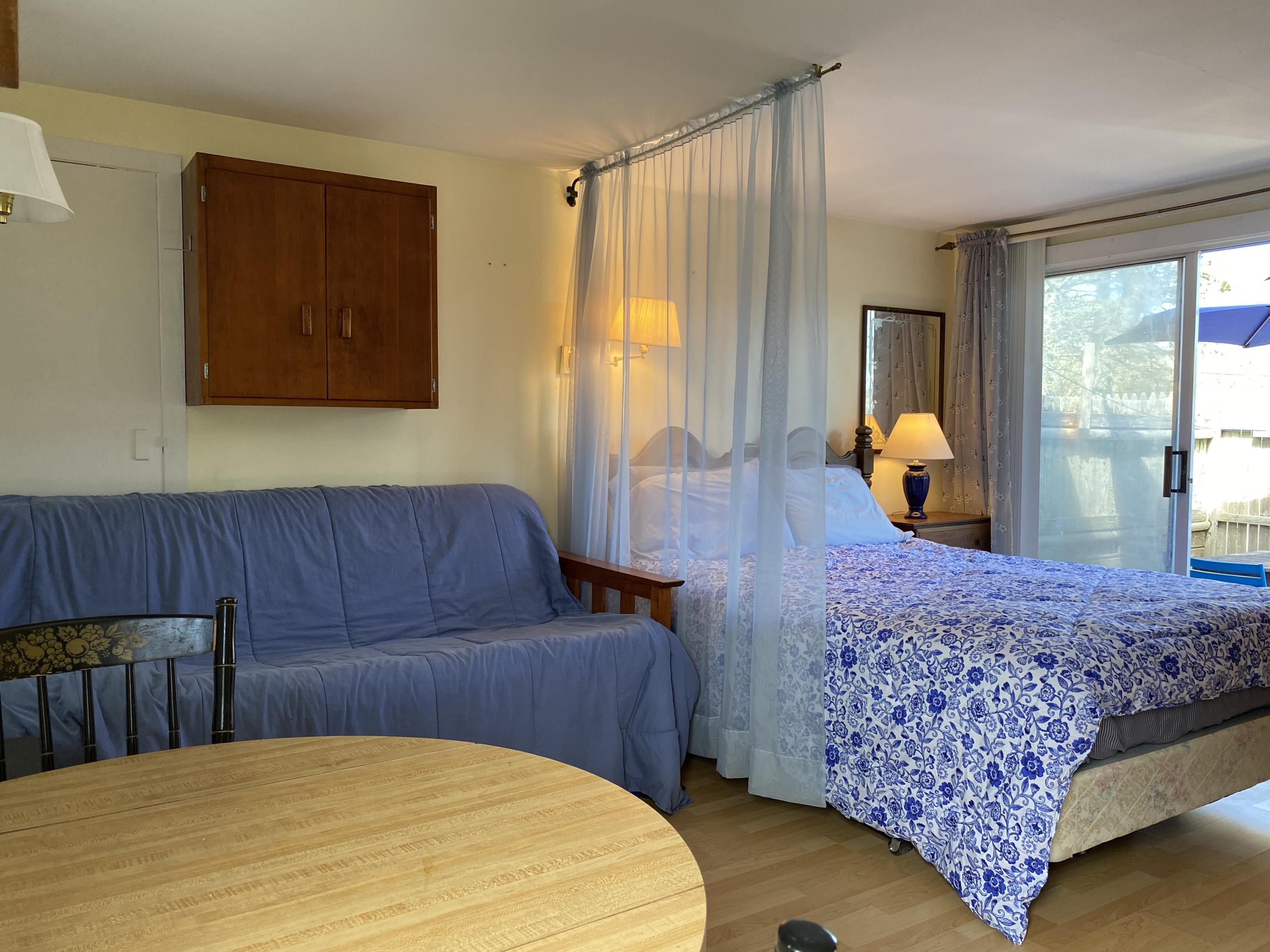 465 Lower County Road, Unit 3A Dennis Port, MA 02639 - Photo 4 of 33 a bedroom with a large bed and a dresser